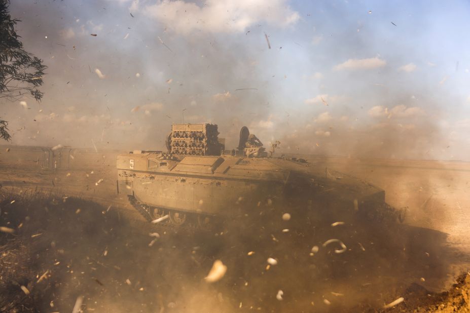 An Israeli armored personnel carrier whips up dust near Israel's border with Gaza on Sunday, October 15.