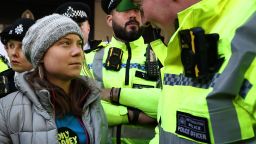 TOPSHOT - A police officer speaks to Swedish climate activist Greta Thunberg moments before she was arrested outside the InterContinental London Park Lane during the "Oily Money Out" demonstration organised by Fossil Free London and Greenpeace on the sidelines of the opening day of the Energy Intelligence Forum 2023 in London on October 17, 2023. (Photo by HENRY NICHOLLS / AFP) (Photo by HENRY NICHOLLS/AFP via Getty Images)