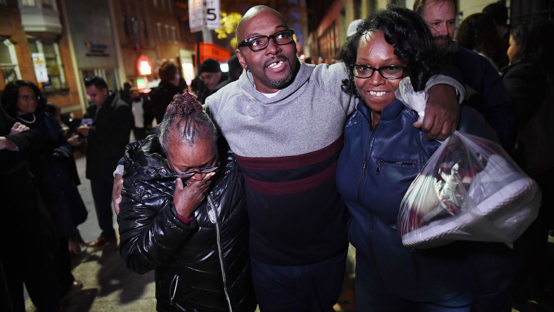 Mary Stewart, left, walks with her son, Andrew Stewart and her daughter, Ulonda Stewart, after his release.