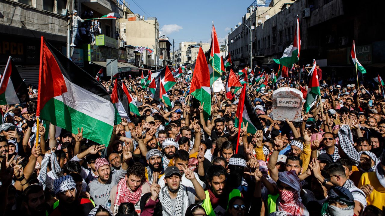 Protesters wave Palestinian flags during a pro-Palestinian demonstration in Amman, Jordan on Friday.