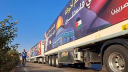 A convoy of trucks carrying aid supplies for Gaza from Egypt waits on the main Ismailia desert road, about 300 km east of the Egyptian border with Gaza, on the way to the Rafah crossing on October 16, 2023.