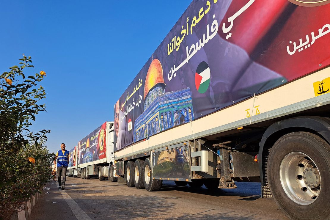 A convoy of trucks carrying aid supplies for Gaza from Egypt waits on the main Ismailia desert road, about 300 km east of the Egyptian border with Gaza, on October 16, 2023.