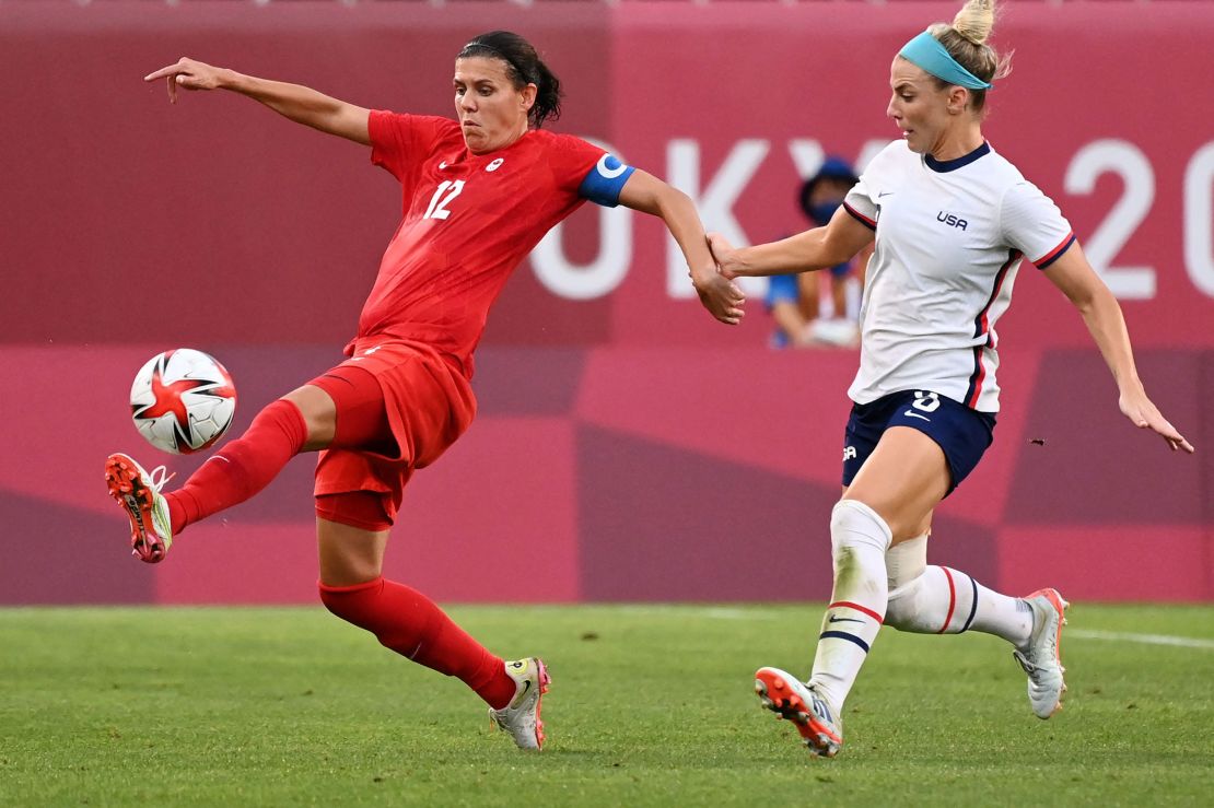 TOPSHOT - Canada's forward Christine Sinclair is marked by USA's midfielder Julie Ertz (R) during the Tokyo 2020 Olympic Games women's semi-final football match between the United States and Canada at Ibaraki Kashima Stadium in Kashima on August 2, 2021. (Photo by MARTIN BERNETTI / AFP) (Photo by MARTIN BERNETTI/AFP via Getty Images)