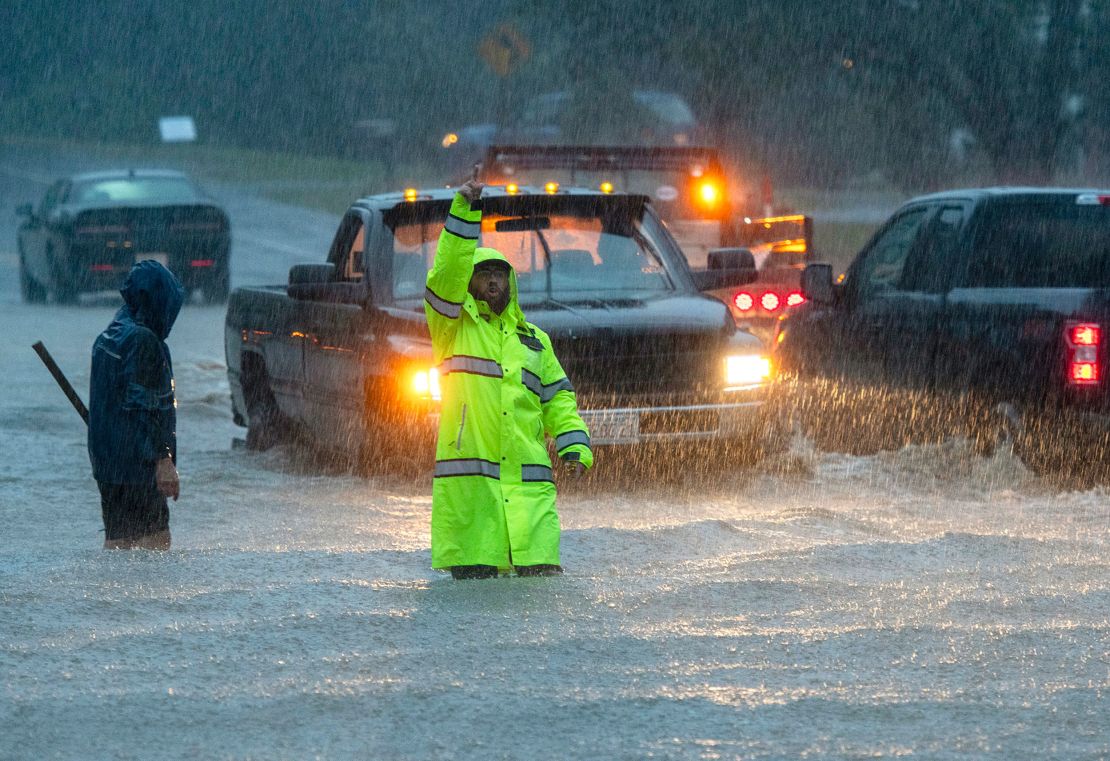 Vehicles make their way through a flooded street during heavy rain in Leominster, Massachusetts, on Monday, Sept. 11, 2023. 