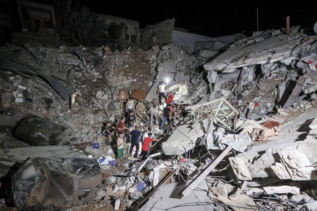 People inspect an area around the Greek Orthodox Church after an Israeli strike in Gaza City, on October 20. 