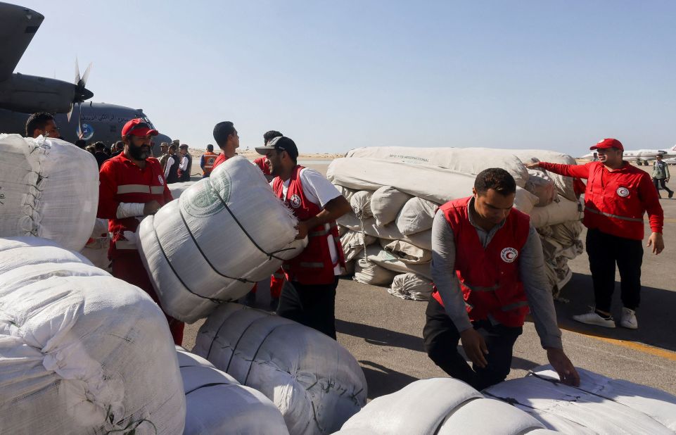 Egyptian Red Crescent members coordinate aid for Gaza, as United Nations Secretary-General Antonio Guterres speaks to the media, at El-Arish Airport in Egypt on October 20.