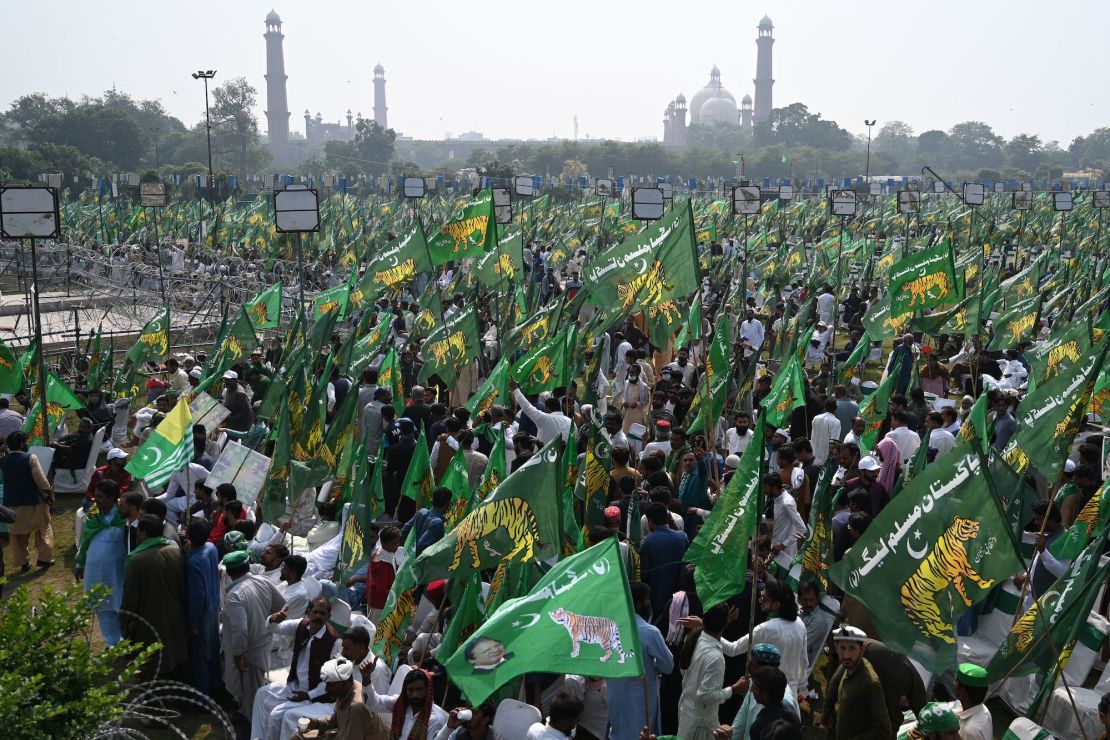 Supporters of Nawaz Sharif wait for his arrival for a welcoming rally at a park in Lahore on October 21, 2023.