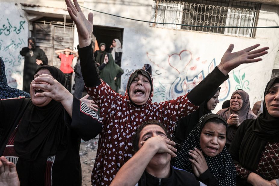 Relatives mourn for a family killed in an Israeli airstrike in Gaza City on Saturday, October 21.
