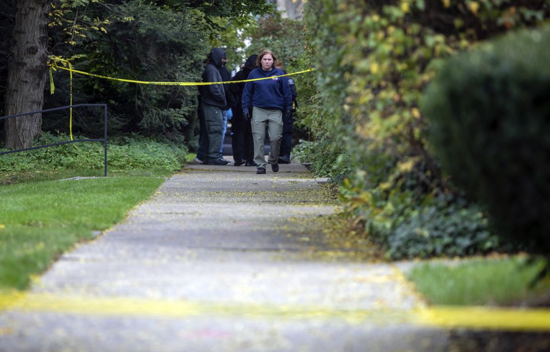 A law enforcement agent walks near the scene where Samantha Woll was found dead in Detroit on Saturday.