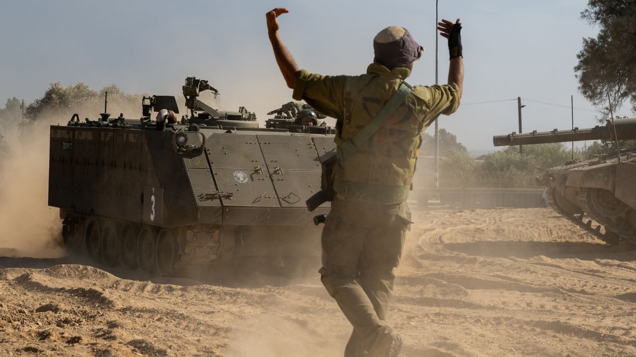 An IDF soldier guides an armored personnel carrier  on October 21, 2023 in Southern Israel. 
