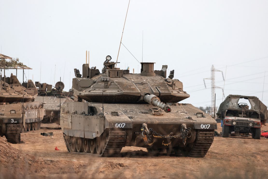 An Israeli tank and military vehicles are seen near Israel's border with the Gaza Strip, in Israel.