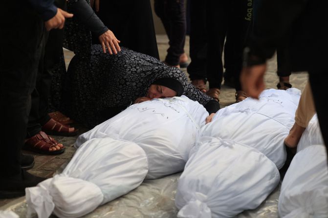 A Palestinian woman mourns over the body of a relative killed in an overnight Israeli airstrike in Rafah, Gaza, on Sunday, October 22.