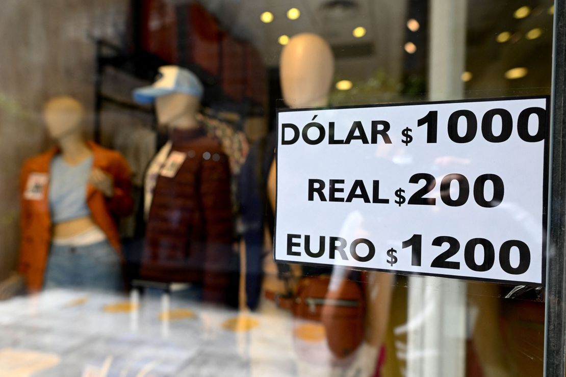 A sign with exchange currency values of the unofficial so-called "Blue Dollar" of the parallel market is displayed in the window of a store in Buenos Aires on October 10, 2023.