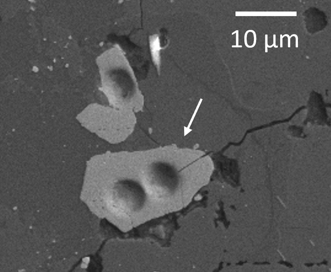 A lunar zircon grain is shown under a microscope.