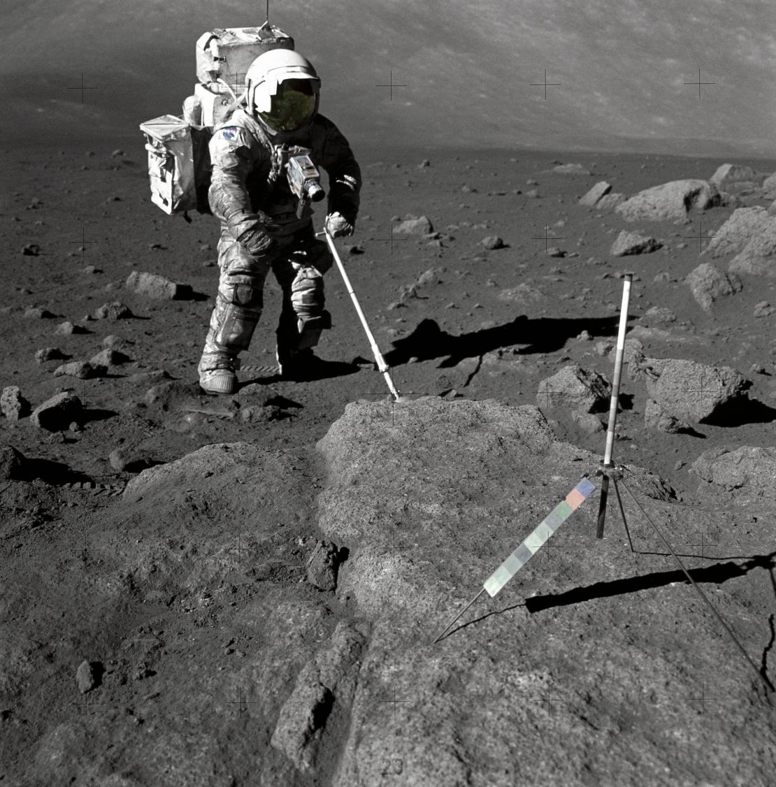 Geologist-Astronaut Harrison Schmitt, Apollo 17 lunar module pilot, uses an adjustable sampling scoop to retrieve lunar samples during the second extravehicular activity (EVA-2), at Station 5 at the Taurus- Littrow landing site. The cohesive nature of the lunar soil is born out by the 