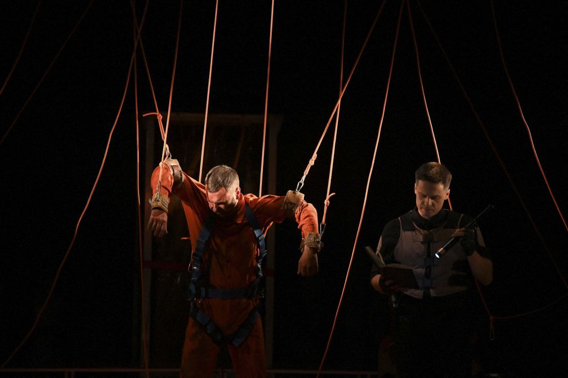 Actors perform the adapted novel by George Orwell "1984" on the stage of the Podil theatre located in the center of Ukrainian capital of Kyiv on June 25, 2022. - Its resonance with Ukrainian news has never been so striking: adapted from the famous novel by George Orwell, the play "1984" was replayed on June 25 in Kyiv for the first time since the start of the Russian invasion, for the delight of actors and spectators - until the show is interrupted by a bombing alert. (Photo by Sergei SUPINSKY / AFP) (Photo by SERGEI SUPINSKY/AFP via Getty Images)