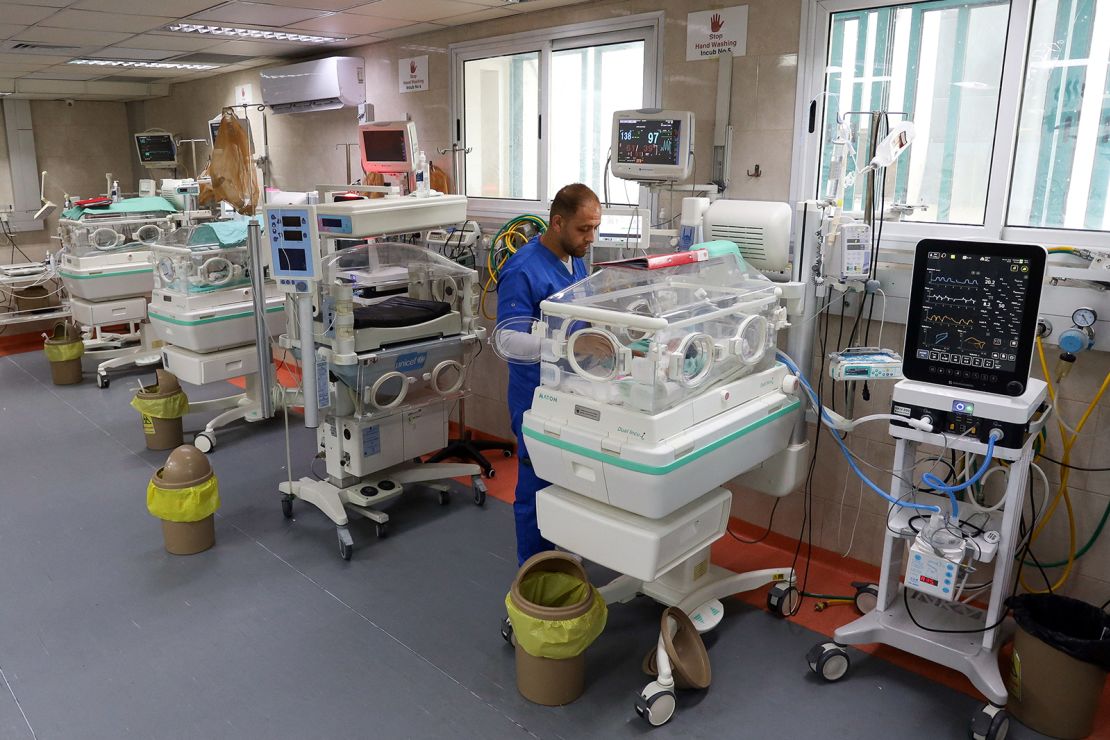 A medical worker assists a premature Palestinian baby who lies in an incubator at the maternity ward of Shifa Hospital, in Gaza on October 22, 2023.