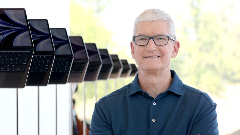 Apple CEO Tim Cook stands next to a display of newly redesigned MacBook Air laptop during the WWDC22 at Apple Park on June 06, 2022 in Cupertino, California. 