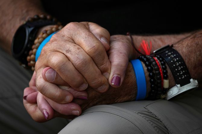 Mourners hold hands during the funeral of Sgt. Yam Goldstein and her father, Nadav, in Kibbutz Shefayim, Israel, on October 23.