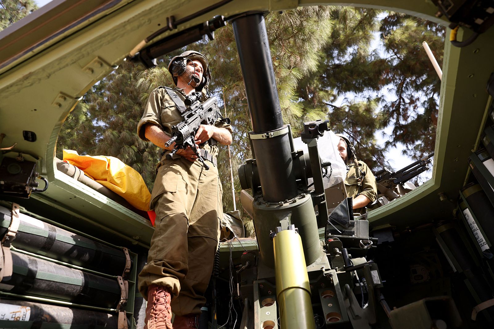 An Israeli soldier stands in an armored vehicle near the Lebanon border on October 23.