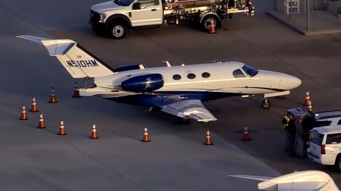 One of the damaged private jets can be seen surrounded by warning cones at the William P. Hobby airport in Houston.