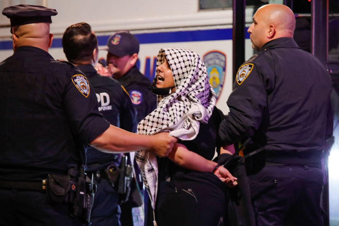 A woman is arrested by police officers after protesters clashed with members of the New York Police Department at a rally in support of Palestinians in Brooklyn on October 21, 2023.
