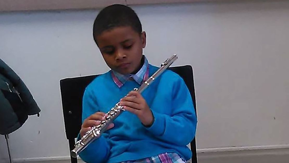 Bryson Hudson, as a child, playing the flute.