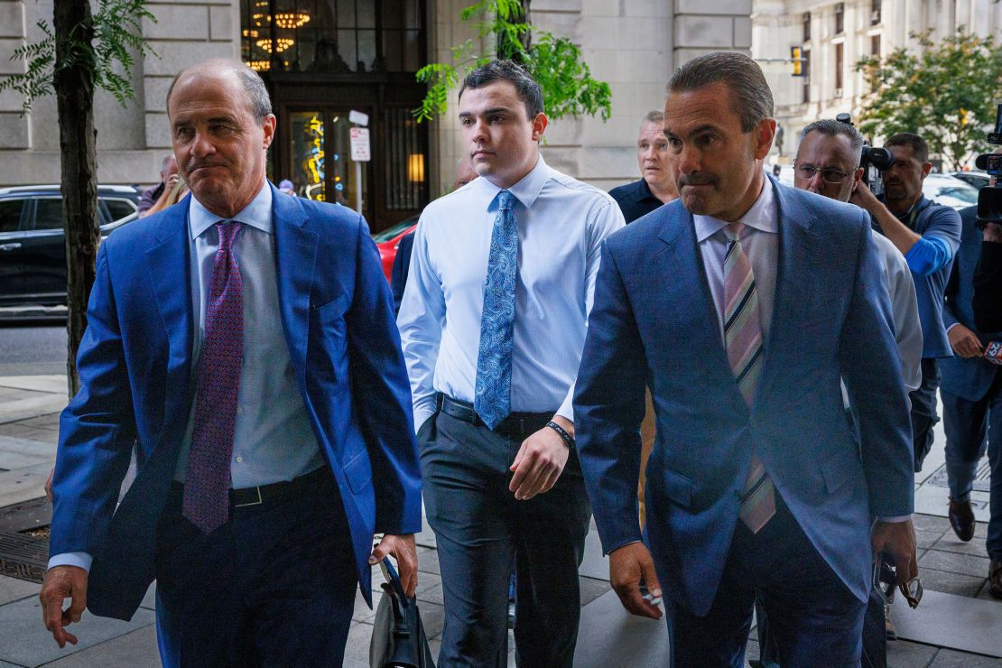 Philadelphia police officer Mark Dial, center, arrives at the Juanita Kidd Stout Center for Criminal Justice in Philadelphia, Tuesday, Sept. 19, 2023, with attorneys for a bail hearing. Brian McMonigle is at left and at right is Fortunato Perri. Dial, a Philadelphia police officer charged in the shooting death of a driver last month is back in custody following the revocation of his bail after prosecutors challenged the constitutionality of his release.(Alejandro A. Alvarez/The Philadelphia Inquirer via AP)