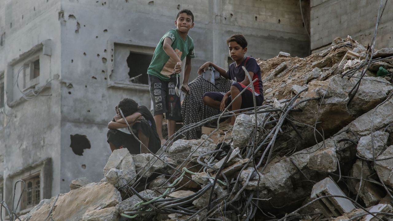 10/25/2023 Gaza, Palestine. Three children wander around the rubbles of ruined buildings that were destroyed by the Israeli airstrikes in Gaza. (Photo by Youssef Alzanoun / Middle East Images / Middle East Images via AFP) (Photo by YOUSSEF ALZANOUN/Middle East Images/AFP via Getty Images)