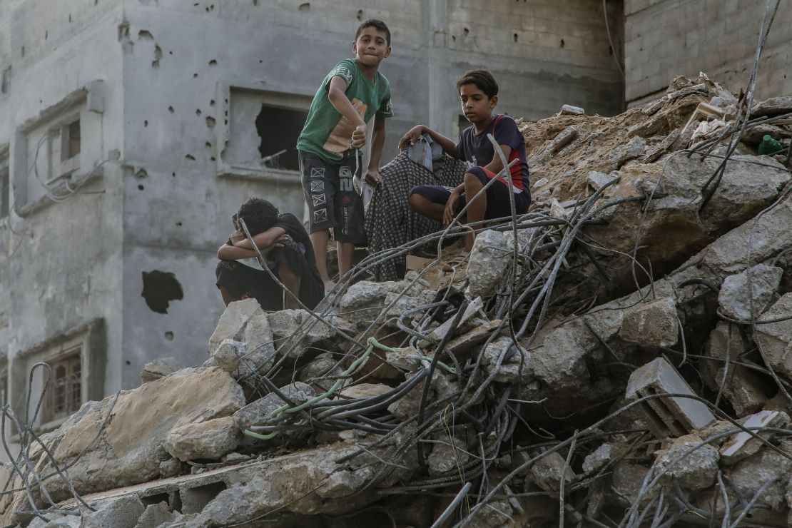 10/25/2023 Gaza, Palestine. Three children wander around the rubbles of ruined buildings that were destroyed by the Israeli airstrikes in Gaza. (Photo by Youssef Alzanoun / Middle East Images / Middle East Images via AFP) (Photo by YOUSSEF ALZANOUN/Middle East Images/AFP via Getty Images)