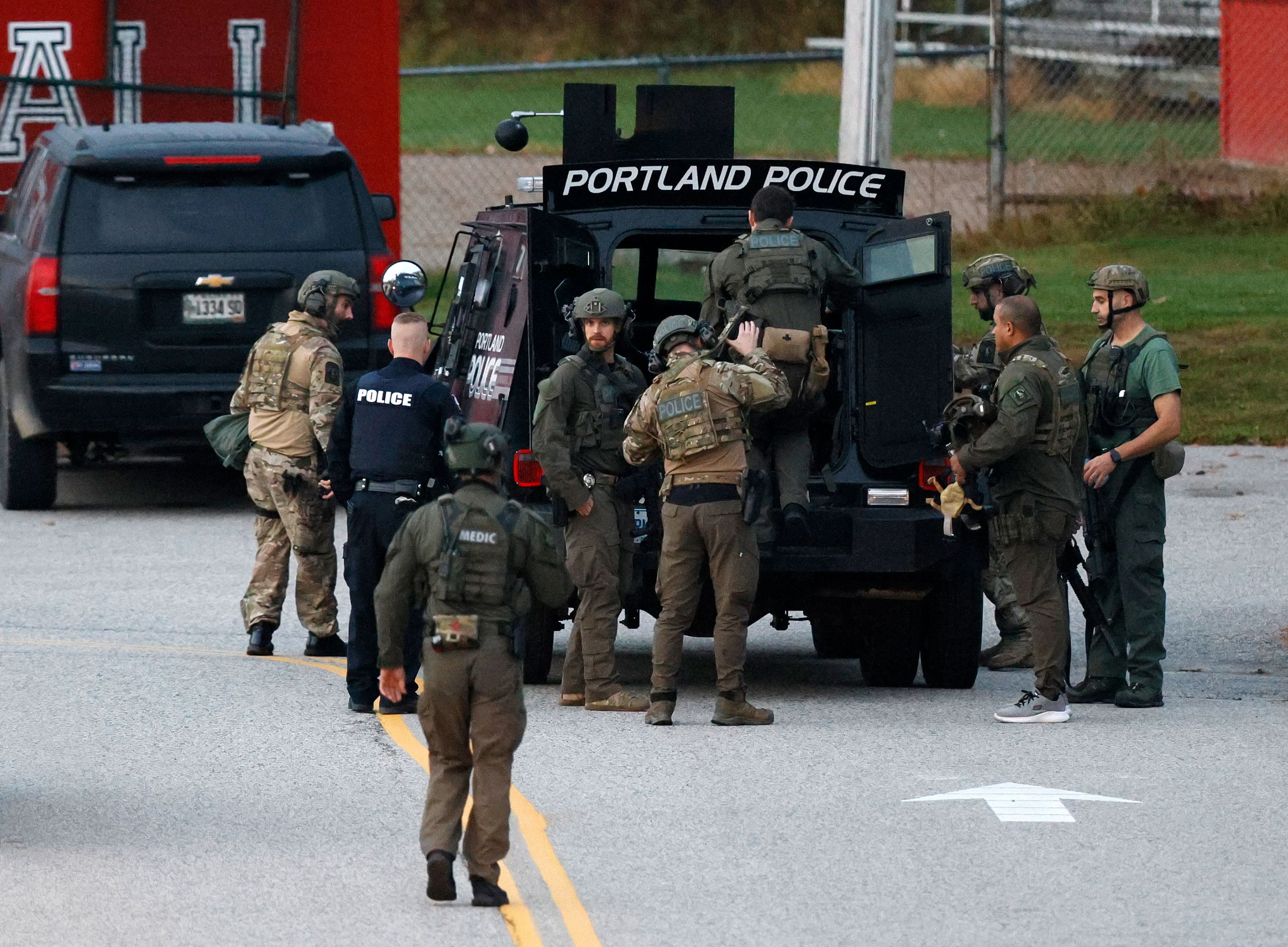 Law enforcement officials load into a tactical vehicle at Lisbon High School on Thursday.