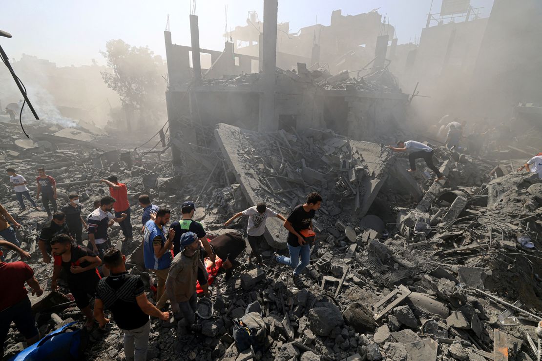 People search for survivors and the bodies of victims through the rubble of buildings destroyed during Israeli bombardment, in Khan Yunis in the southern Gaza Strip on October 26, 2023, amid the ongoing battles between Israel and the Palestinian group Hamas. Thousands of civilians, both Palestinians and Israelis, have died since October 7, 2023, after Palestinian Hamas militants based in the Gaza Strip entered southern Israel in an unprecedented attack triggering a war declared by Israel on Hamas with retaliatory bombings on Gaza. (Photo by MAHMUD HAMS / AFP) (Photo by MAHMUD HAMS/AFP via Getty Images)