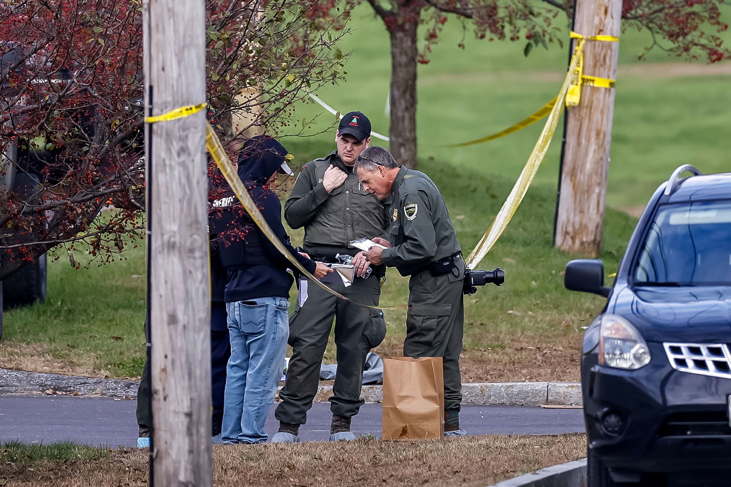 Law enforcement personnel work outside Schemengees Bar and Grille on Thursday.