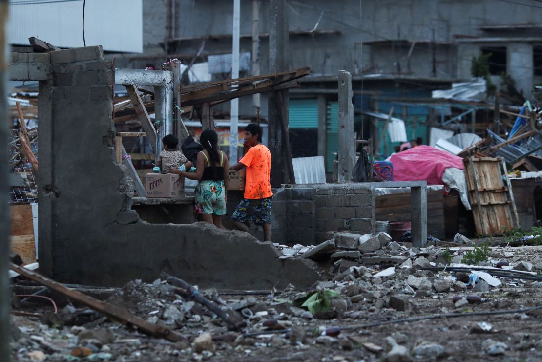 People stand near street stalls damaged by Hurricane Otis near the entrance to Acapulco, in the Mexican state of Guerrero, Mexico October 25, 2023. REUTERS/Henry Romero