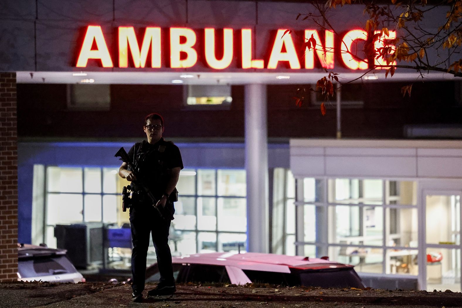 A police officer stands guard in front of the Central Maine Medical Center.