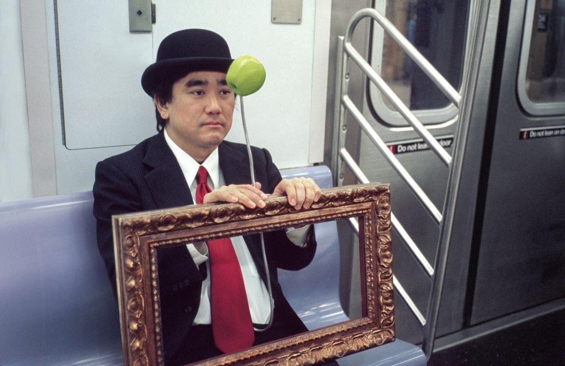 Surrealist René Magritte holds his own self-portrait frame.