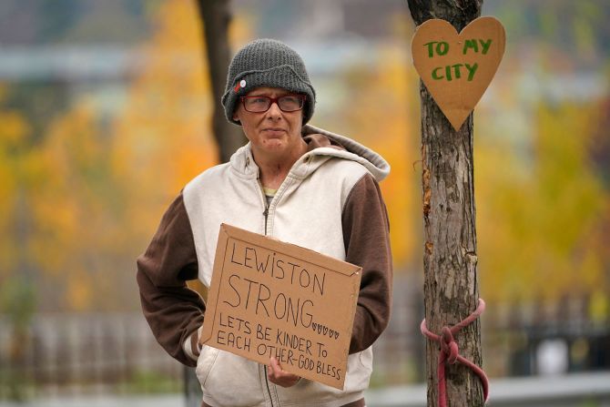 Jess Paquette holds a sign showing her support in Lewiston, Maine, on October 26.