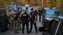 BOWDOIN, MAINE - OCTOBER 26: Law enforcement officials gather in the road leading to the home of the suspect being sought in connection with two mass shootings on October 26, 2023 in Bowdoin, Maine. Police are searching for U.S. Army Reservist Robert Card, 40, who is wanted in the shooting deaths of 18 people at a bowling alley and a bar last night in nearby Lewiston. At least 13 others were wounded in the rampage. (Photo by Joe Raedle/Getty Images)