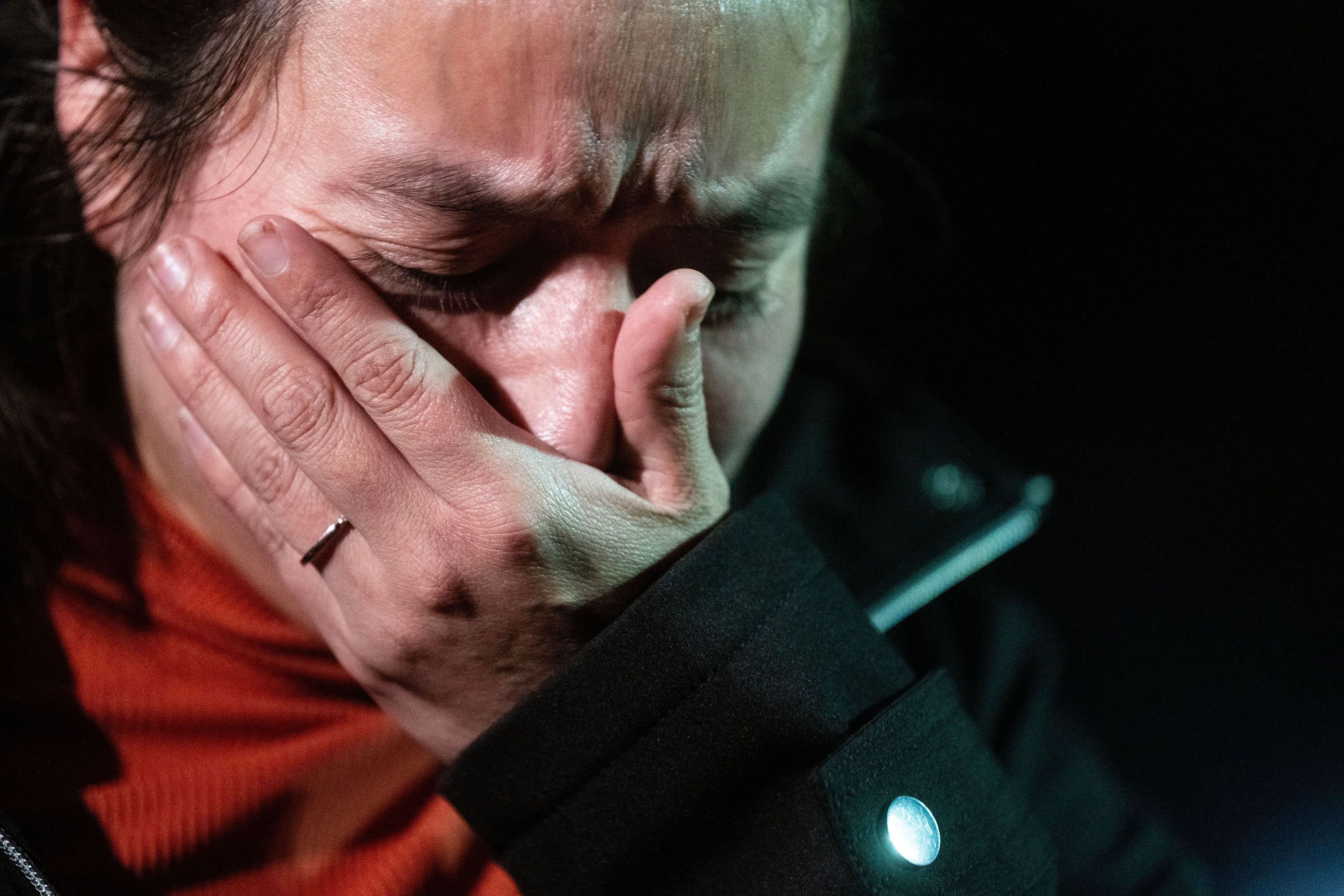 Maria Wilson reacts while speaking to reporters at the reunification center at Auburn Middle School about the unknown status of her loved one on Wednesday.