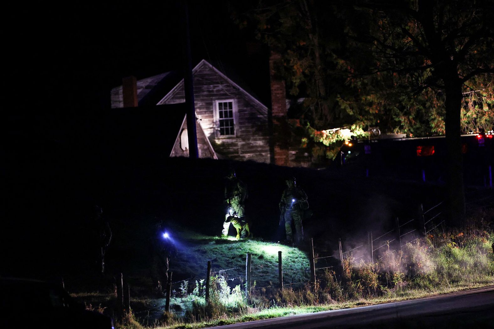 Law enforcement surround a house in Bowdoin, Maine, as they continue their manhunt on Thursday, October 26.