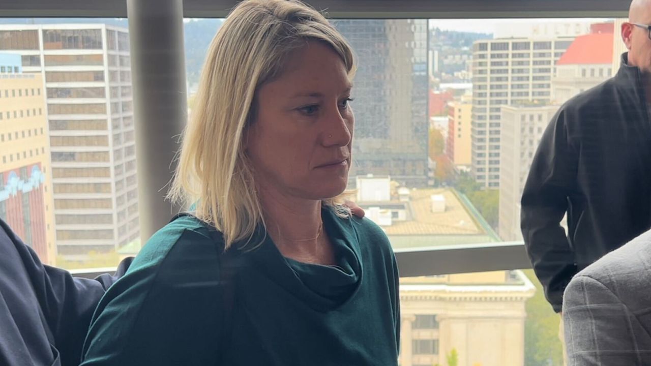 Wife of off-duty Alaska Airlines pilot accused of trying to disrupt a
