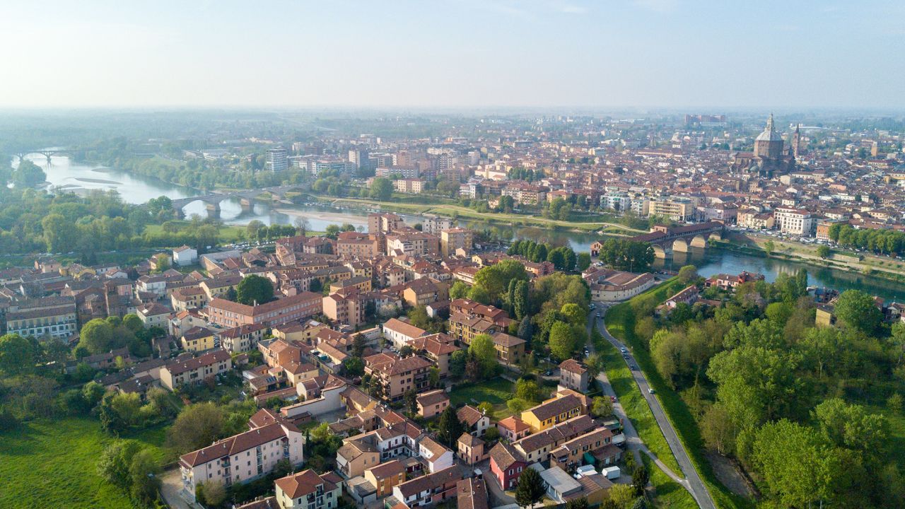 Aerial view of Pavia and the Ticino River, View of the Cathedral of Pavia, Covered Bridge and the Visconti Castle. Lombardia, Italy