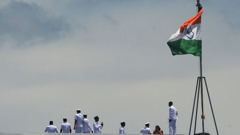 Indian Navy officers gather on the deck of the Indian indigenous aircraft carrier INS Vikrant during its commissioning at Cochin Shipyard in Kochi on September 2, 2022.