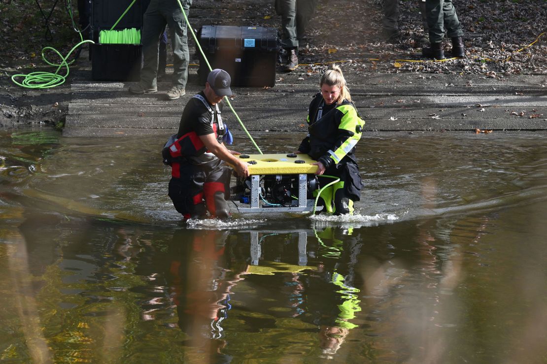 Divers prepare to search the Androscoggin River in Lisbon Falls, Maine, on October 27, 2023, in the aftermath of a mass shooting. Police in Maine struggled for a second day on October 27, 2023, to catch a man who gunned down 18 people with a semi-automatic rifle in a bowling alley and a bar in a town where locals were enjoying an evening out. Robert Card, 40, is accused of being the man seen on security cameras walking into a Lewiston bowling alley on the evening of October 25, 2023, and launching the country's deadliest mass shooting of the year so far. In addition to the 18 murdered at the bowling venue and later in a bar, the US Army reservist is accused of wounding 13. (Photo by ANGELA WEISS / AFP) (Photo by ANGELA WEISS/AFP via Getty Images)