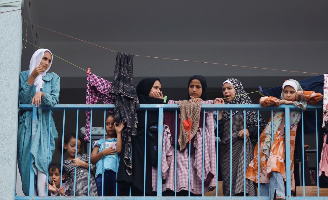 Palestinians, who have fled their homes due to Israeli strikes, watch a nearby Israeli strike as they take shelter in a UN-run school, in Khan Younis in the southern Gaza Strip, October 27, 2023. REUTERS/Mohammed Salem