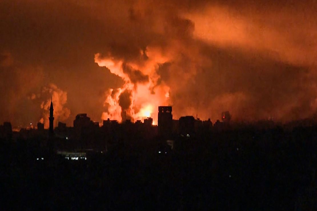 A still from AFP TV footage shows balls of fire rising above Gaza City during an Israeli strike on October 27.