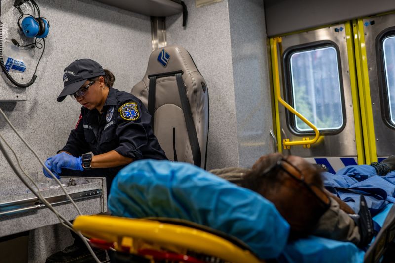 AUSTIN, TEXAS - AUGUST 08: An Austin-Travis County medic assists a patient in an ambulance on August 08, 2023 in Austin, Texas. EMT were called after the patient was found passed out and dehydrated near the Texas State Capitol. The city of Austin continues grappling with a prolonged heat wave, with excessive heat-advisories being issued across the state.  (Photo by Brandon Bell/Getty Images)