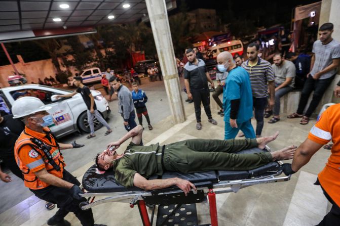 A Palestinian man injured in an Israeli airstrike is carried on a stretcher at Nasser Medical Hospital, in Khan Younis, Gaza, on October 27, 2023.