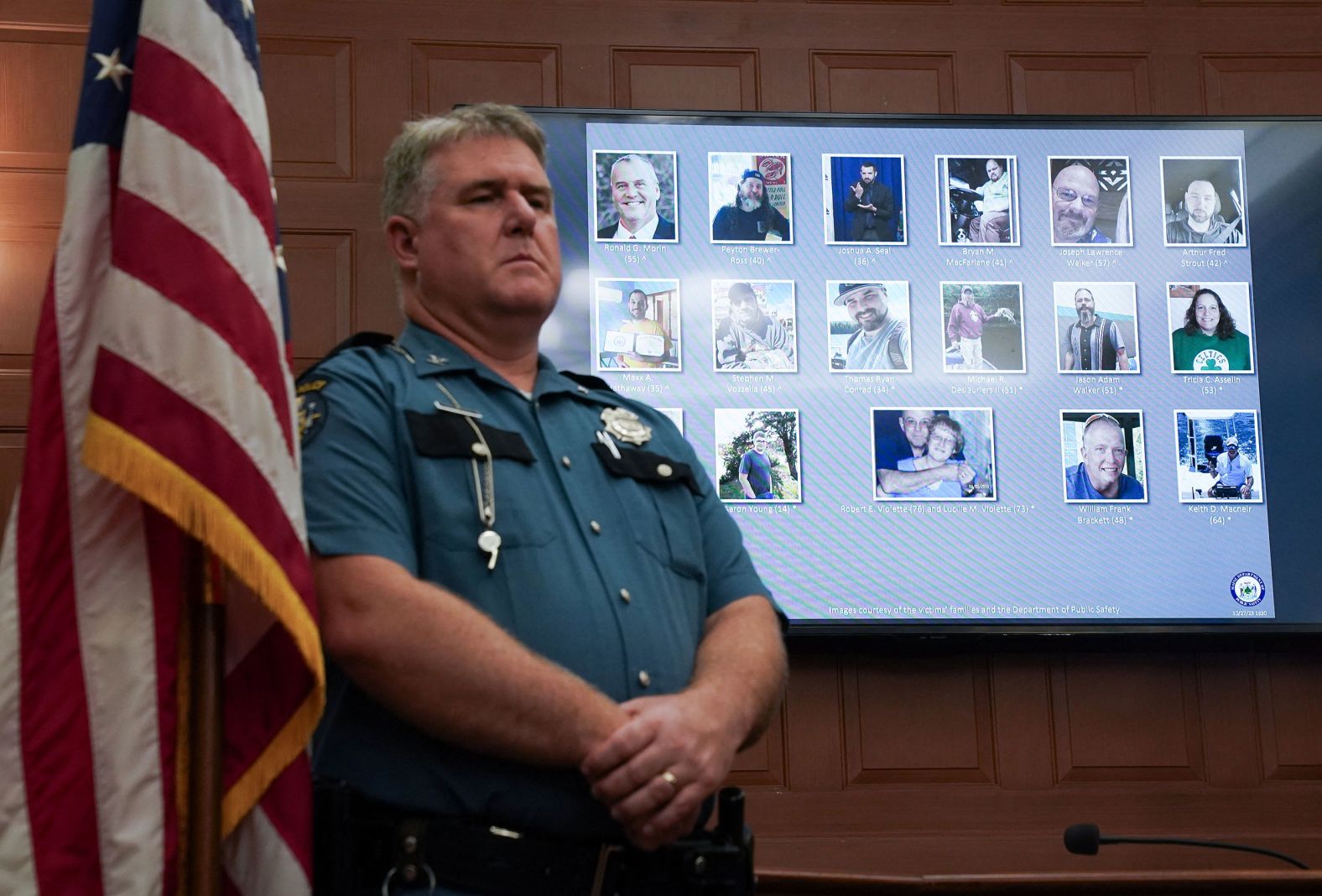 A screen displays pictures of people killed in the shootings as their names are read during a press conference at Lewiston City Hall on Friday.
