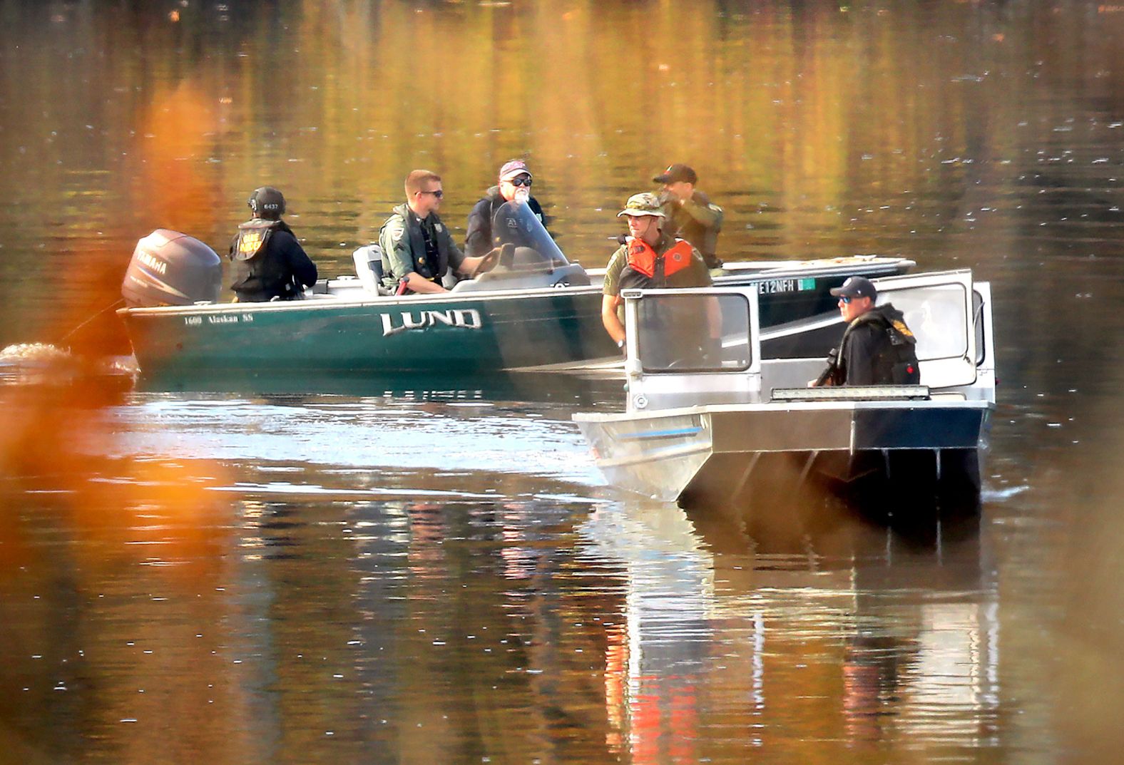Police and ATF agents search the Androscoggin River in Lisbon on Friday.